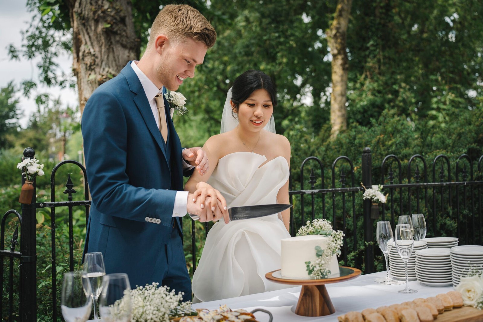 Newlyweds cutting their wedding cake